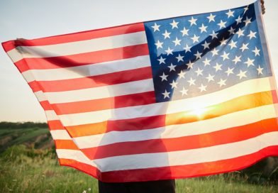 4th of July. American woman with the national American flag